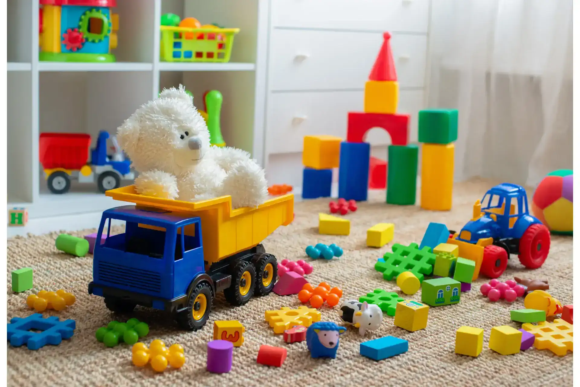 assorted baby toys placed on the floor of a child’s bedroom