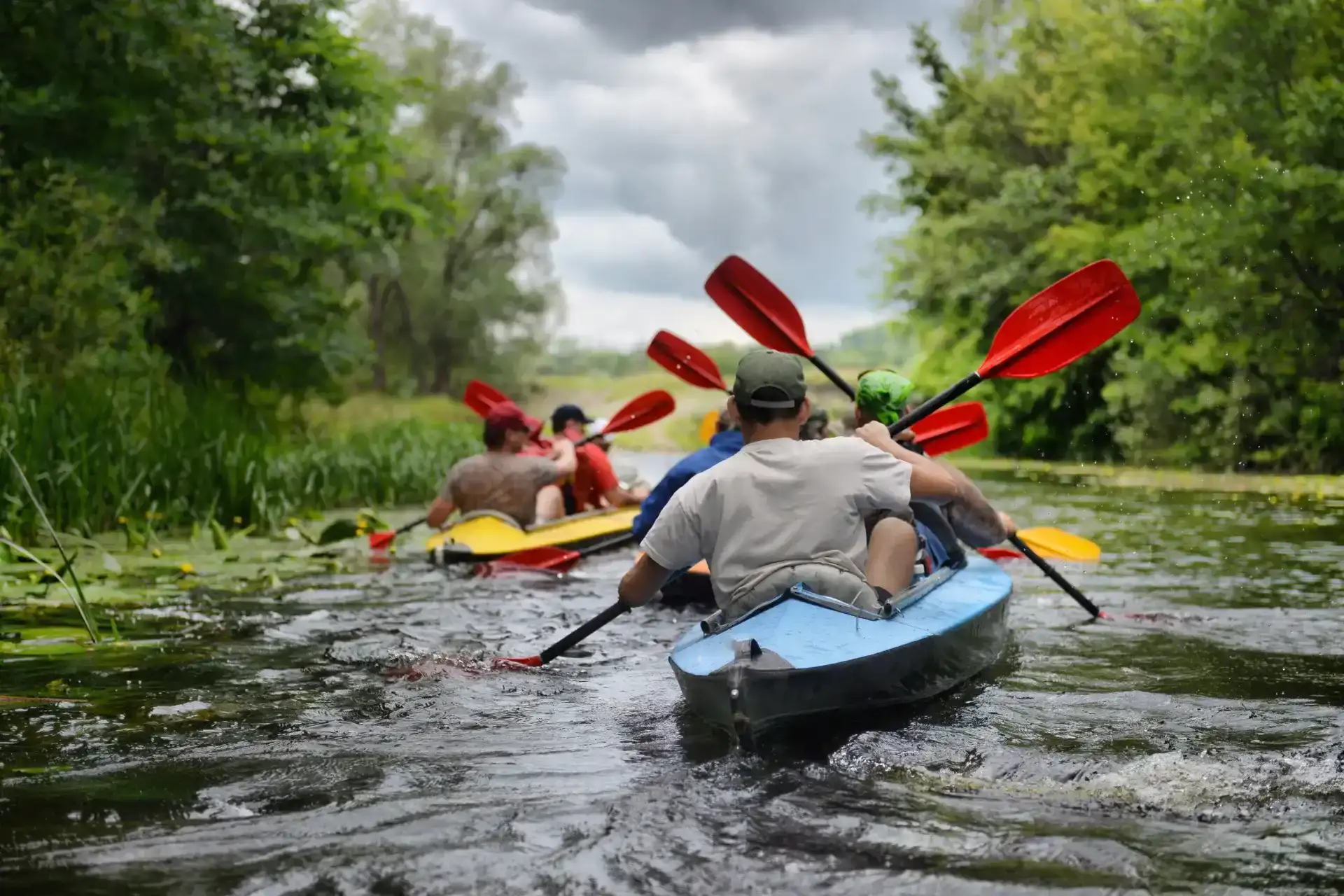 kayakers navigating white water rapids as a group