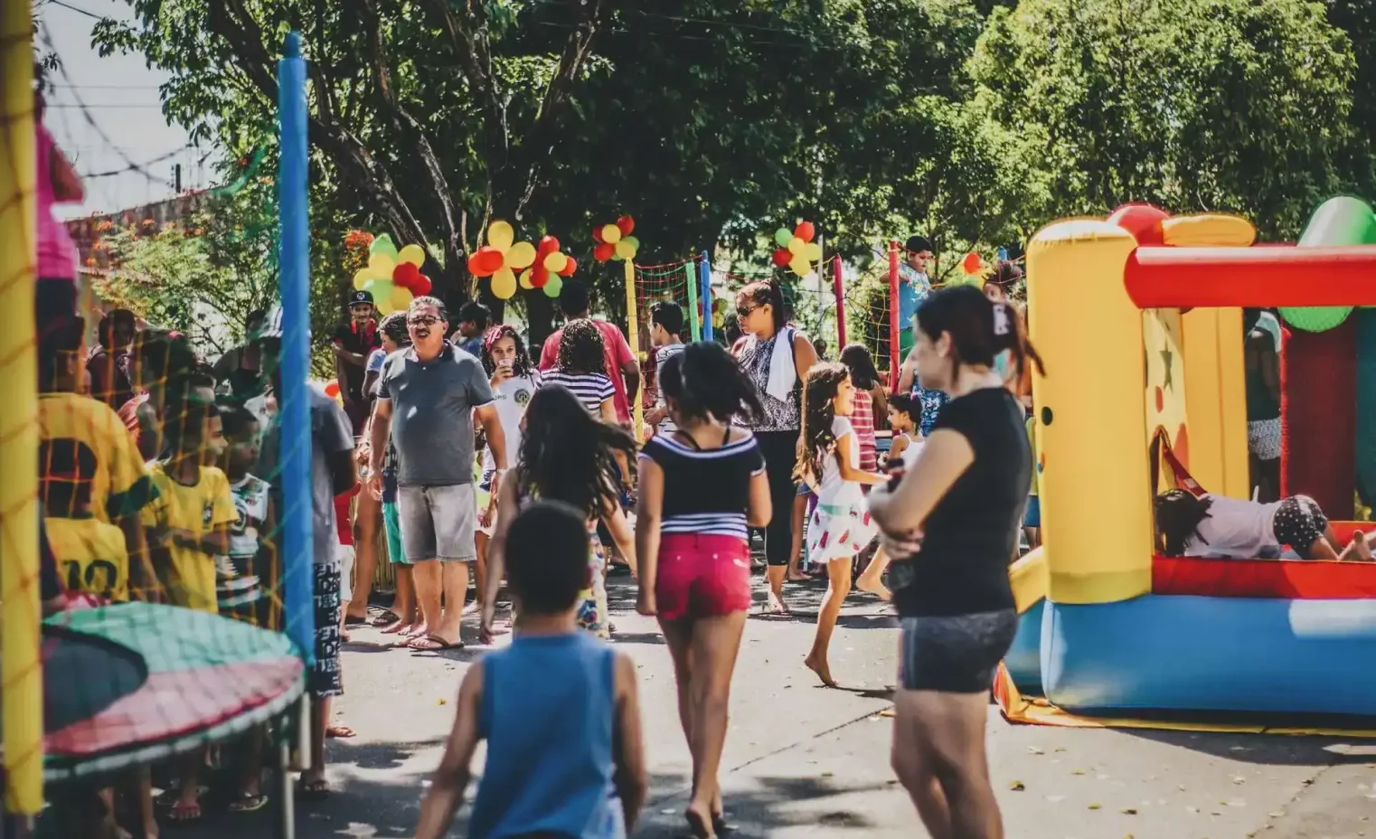 colorful inflatable bounce house castles set up in a suburban garden for a children's birthday party.webp