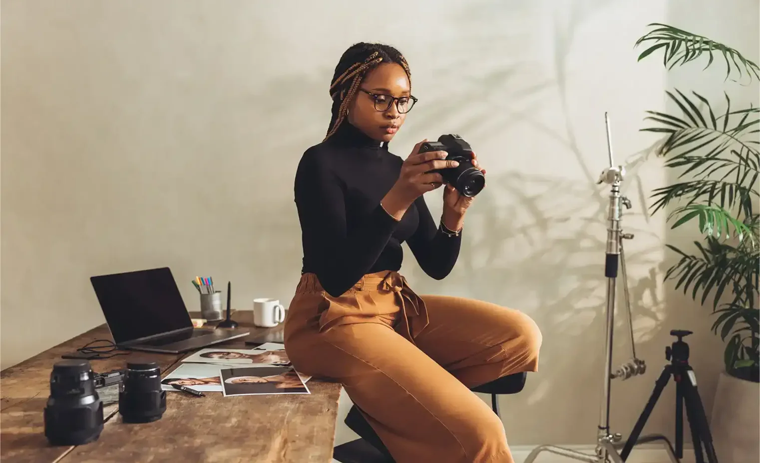 photographer inspecting a professional DSLR camera and telephoto lens.webp