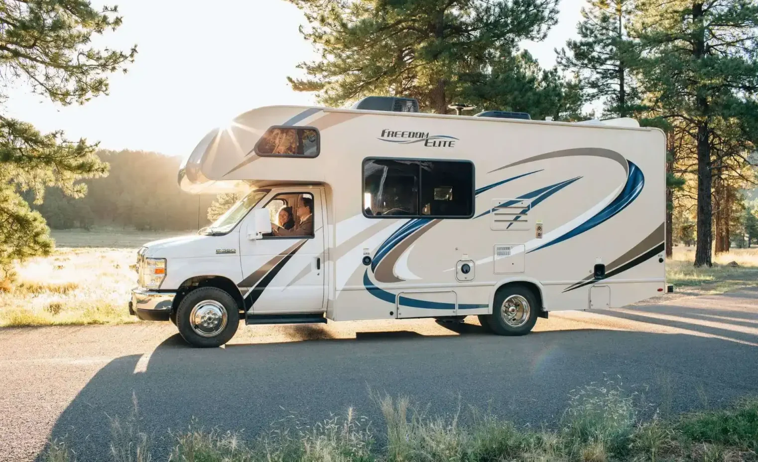 white motorhome rental parked at a mountain overlook campsite.webp