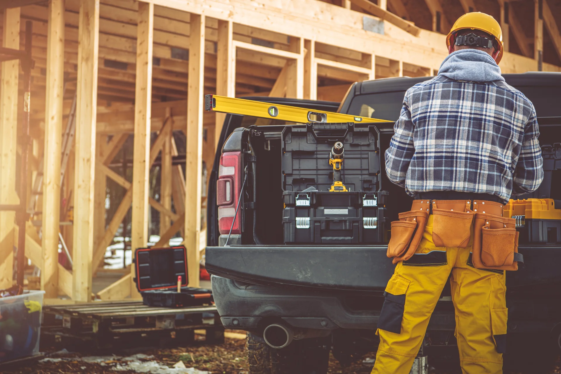 Construction worker unloading heavy machinery at a construction site