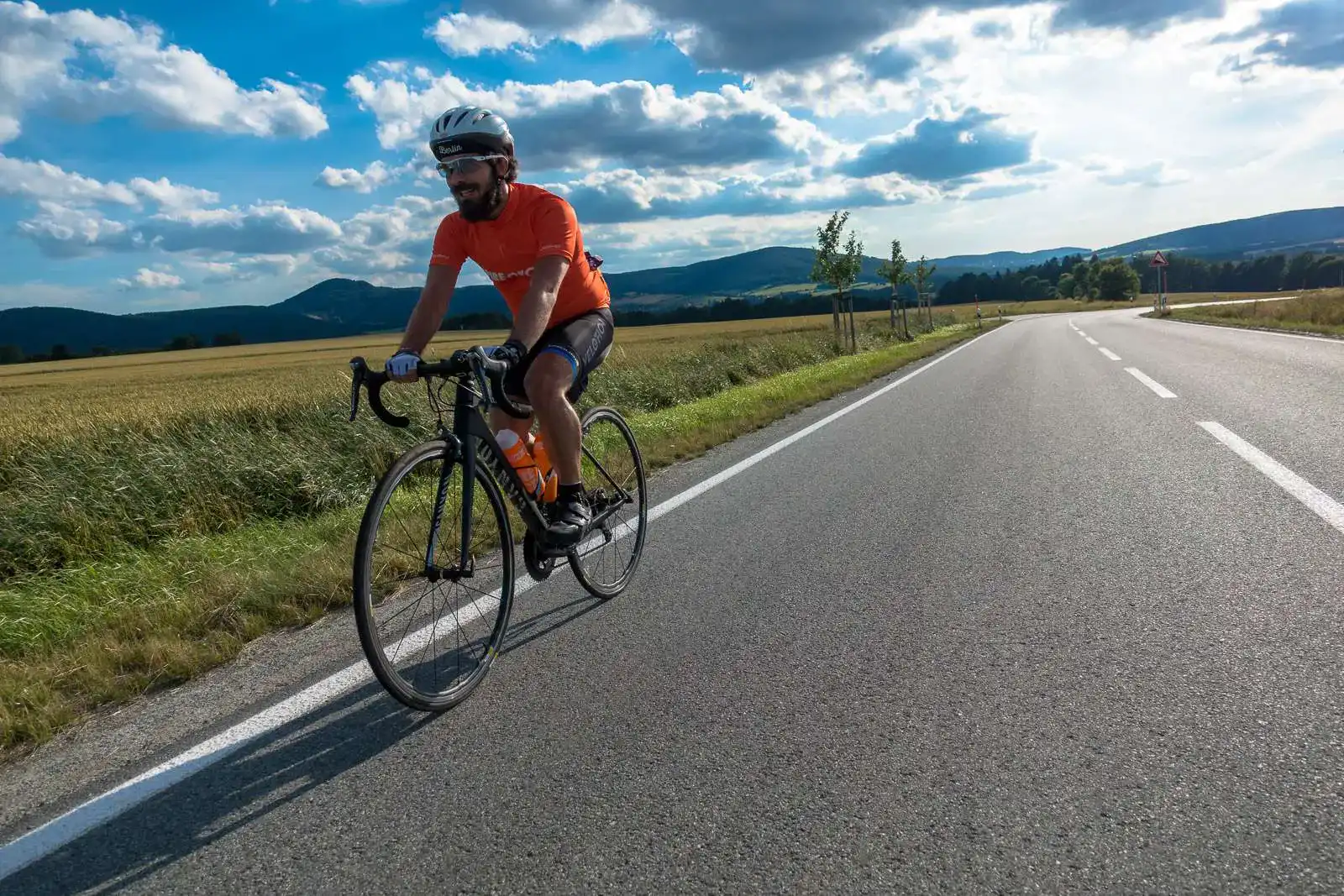 Man riding into the sunset on his high-performance bicycle